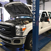 White truck with hood open