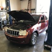 Red SUV with hood open