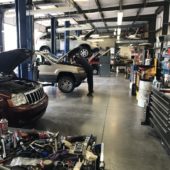 Mechanic working on a white SUV